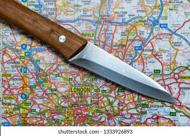 LONDON, UK - MARCH 9 2019: A Knife On A Map Of London, England. Knife Crime In London Concept. 