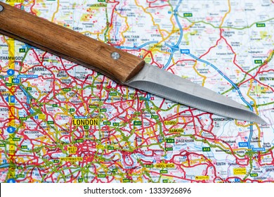 LONDON, UK - MARCH 9 2019: A Knife On A Map Of London, England. Knife Crime In London Concept. 