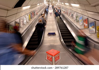 LONDON, UK - MAY 12 2015:Bristish passengers using London Underground escalator. The Deepest station below street level is Hampstead (Northern line) - 58.5 metres.