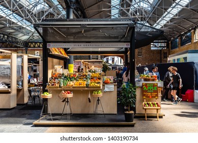 London, UK - May 14, 2019:  Old Spitalfields Market With Unidentified People. Fruits Stall. The Market  Hosts Arts And Craft And Street Food Market.