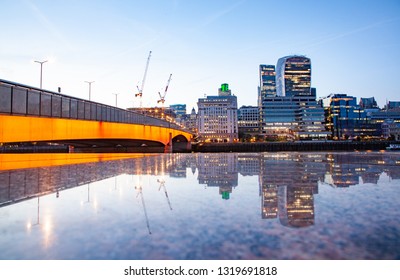 LONDON, UK - MAY, 2016: bridge and skyscrapers reflecting at night