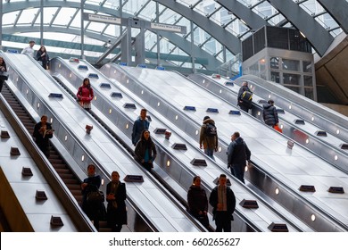 London, UK - May 24, 2017 - Entrance of Canary Wharf underground station with commuters on escalators