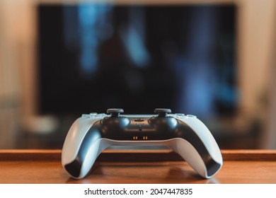London, UK - May 25, 2021: Playstation 5 (PS5) controller on the table inside a flat, selective focus. Playstation 5 is the latest video game console by Sony released in November 2020