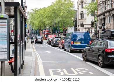 LONDON, UK - May 5, 2019 Red Bus And Cars In Streets Of London, City Traffic System. Bus Lane