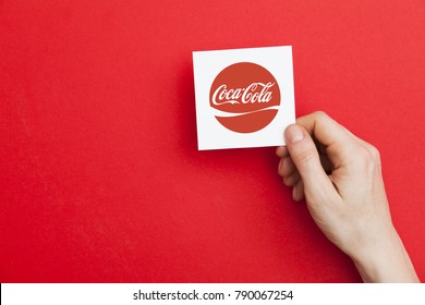 LONDON, UK - May 7th 2017: Hand Holding Coca Cola Logo. Coca Cola Is A Global Soft Drinks Company