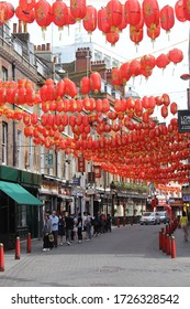 London / UK - May 8 2020: People Queuing Outside A Chinese Supermarket In Lisle Street, Chinatown In Central London During Covid 19 Lockdown