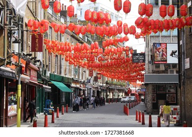 London / UK - May 8 2020: People Queuing Outside A Chinese Supermarket In Lisle Street, Chinatown In Central London During Covid 19 Lockdown