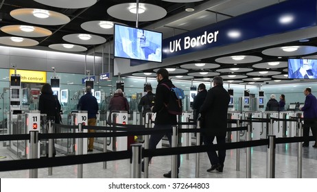 LONDON, UK - NOV 18, 2015: Air travelers queue at border passport control entrance gates at Heathrow Airport. The British aviation hub is the busiest in the European Union by passenger traffic.