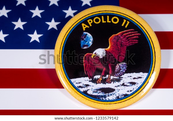 London, UK - November 15th 2018: The badge of the historic Apollo 11 moon landing, pictured over the flag of the United States of America.