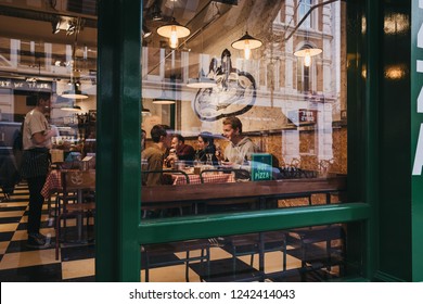 London, UK - November 21, 2018: View Through The Window Of People Inside A Restaurant In Covent Garden, An Area Of London Popular For Cafes And Shops.