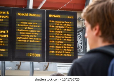 London, UK - November 25, 2018 - A Passenger Looking At Train Timetable At Paddington Railway Station