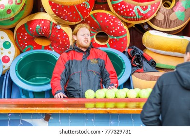 London, UK - November 25 - Carnival game operator soliciting customers at the Christmas funfair Winter Wonderland