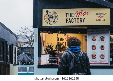 London, UK - November 26, 2019: Man Ordering Food From Mac Factory Stall In Camden Market, London. Started With 16 Stalls In 1974, Camden Market Is One Of The Busiest Retail Destinations In London.