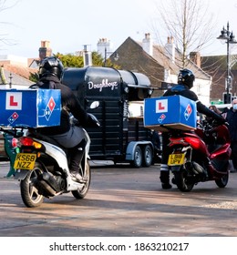 London UK, November 28 2020, Two Domino Pizza Home Delivery Drivers Riding Scooters During COVID-19 Lockdown