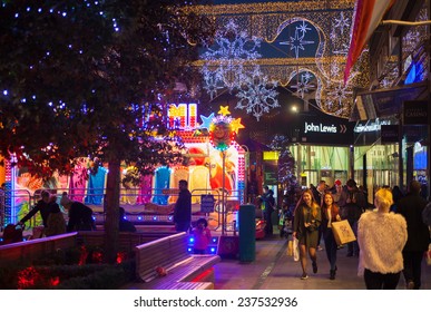  LONDON, UK - NOVEMBER 29, 2014: Stratford village square and big shopping centre decorated with Christmas lights and lots of people shopping around