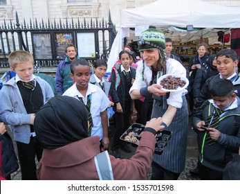 London / UK - November 4th 2011: A School Trip To Occupy London Gets Offered Cake From The Camp Kitchen