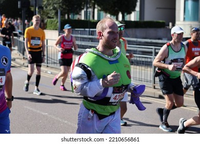 London, UK - Oct 02 2022: London Marathon. Runners At Canary Wharf. Space Suit.