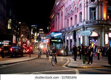 LONDON, UK - OCT 4: People Stroll In Piccadilly On A Friday Night In London On October 4, 2013. From Pubs To Upmarket Bars, Nightclubs And Late Night Shopping, Piccadilly Is A Popular Nightlife Area.