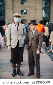 London UK - October 10, 2021: Two Stylish Asian Men At The Classic Car Boot Sale Retro Festival.