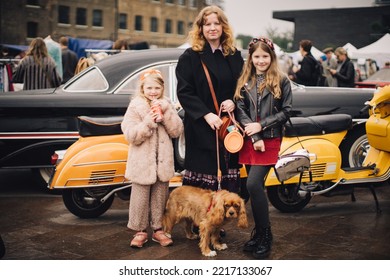 London UK - October 10, 2021: Family With A Dog At The Classic Car Boot Sale By Vintage - A Retro Culture Festival.