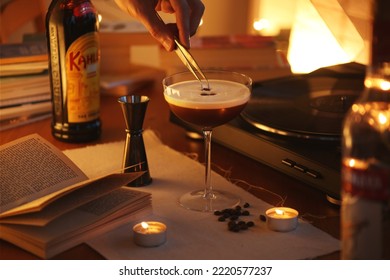 LONDON, UK - OCTOBER 10, 2022:  Espresso Martini Cocktail With Bottle Of Kahlua In The Background