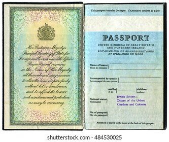 LONDON, UK - OCTOBER 14, 2014: The first pages of old British passport, isolated on white background