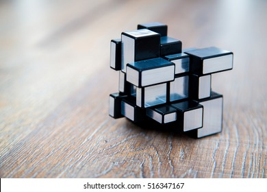 London, UK. October 16, 2016. Modified modern 3D Rubik's cube on the wooden background. Modern Rubik's cube version. Best brain IQ test game.