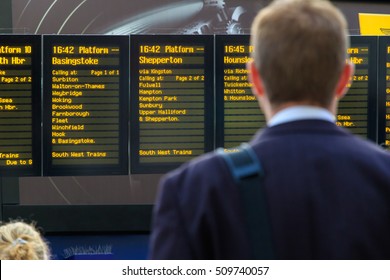 London, UK - October 18, 2016 - Commuter checking timetables at Waterloo train station
