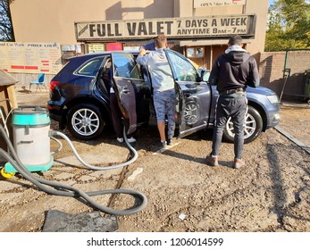 London, Uk, October 18th 2018: Men Washing Luxury Car During A Cold Autumn Day