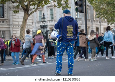 London, UK - October 20, 2018 - Man wearing EU flag pants is carrying megaphone at the People's Vote march