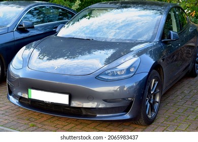 London UK, October 2021: Blue Tesla Electric Car In Car Park On A Sunny Day.