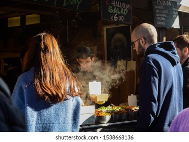 London, UK, October 22, 2019: Pedestrians In Soho. Locals And Tourist At The Street Food Market. 