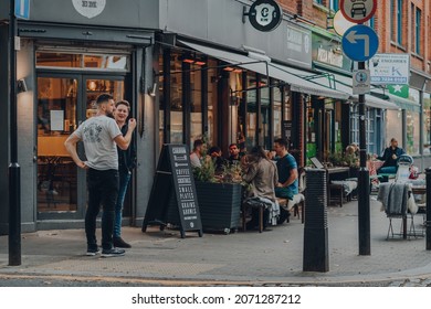 London, UK - October 23, 2021: People outside Caravan coffee shop in Exmouth Market, a semi-pedestrianised street in Clerkenwell, Islington, and a famous street market.