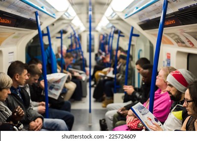 London, UK - October 24, 2014: Commuters Sitting On A Busy And Crowded Victoria Line Underground Train. London Tube Subway Carried A Record 1.26 Billion Passengers In The 2013-2014 Year.