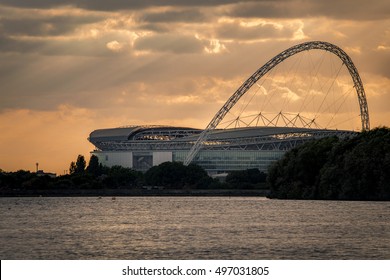 London, UK - October 6, 2016: The wembley stadium from across a body of water at sunset. Wembley is the English national stadium in London, England