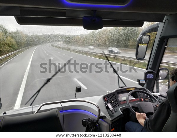London, UK - October\
6,2018: A bus drives along the M4 motorway during a rain storm, The\
British met office has issued a weather warning as storm Callum\
approaches the UK. 