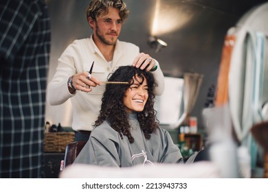 London UK - October 9, 2021: Hairstylist Doing Haircut In Mobile Hair Salon At Classic Car Boot Sale, A Retro Culture Festival.