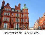 LONDON, UK: Red brick Victorian houses facades in Berkeley Square and Mount Street in the borough of Westminster