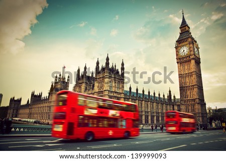 London, the UK. Red bus in motion and Big Ben, the Palace of Westminster. The icons of England in vintage, retro style