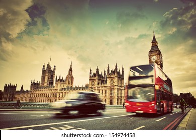 London, the UK. Red bus, taxi cab in motion and Big Ben, the Palace of Westminster. The icons of England in vintage, retro style