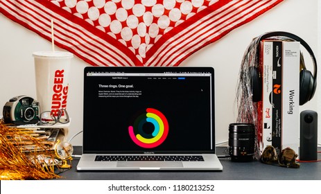 LONDON, UK - SEP 13, 2018: Creative Room Table With Safari Browser On MacBook Pro Laptop Showcasing Apple Computers Website Latest Apple Watch Series 4 Three Rings One Goal Workout Achievement