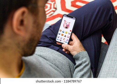 LONDON, UK - SEP 21, 2018: Man Using The New Pig AR Memoji Emoji Face On Apple IPhone Xs With The Immense OLED Retina Display And A12 Bionic Chip