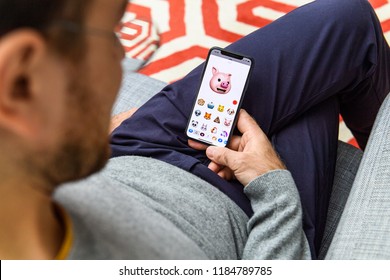 LONDON, UK - SEP 21, 2018: Man Using The New Pig AR Memoji Emoji Face On Apple IPhone Xs With The Immense OLED Retina Display And A12 Bionic Chip