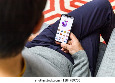 LONDON, UK - SEP 21, 2018: Man Using The New AR Memoji Emoji Face On Apple IPhone Xs With The Immense OLED Retina Display And A12 Bionic Chip