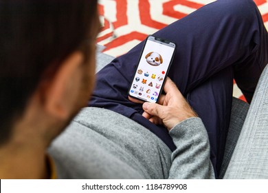 LONDON, UK - SEP 21, 2018: Man Using The New Sad Dog Pet AR Memoji Emoji Face On Apple IPhone Xs With The Immense OLED Retina Display And A12 Bionic Chip, With The Face