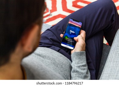 LONDON, UK - SEP 21, 2018: Man Using The New Apple IPhone Xs The Immense OLED Retina Display And A12 Bionic Chip, Looking Over The App Application Flick Photo Community App Flickr Send Notifications