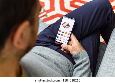 LONDON, UK - SEP 21, 2018: Man Using The New Smiling Dog Pet AR Memoji Emoji Face On Apple IPhone Xs With The Immense OLED Retina Display And A12 Bionic Chip, With The Face