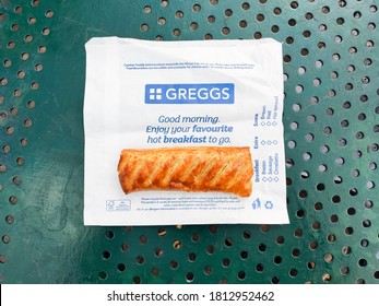 London, UK - September 10, 2020: Flat Lay Of Classic Iconic Greggs Sausage Roll On Branded White And Blue Paper 