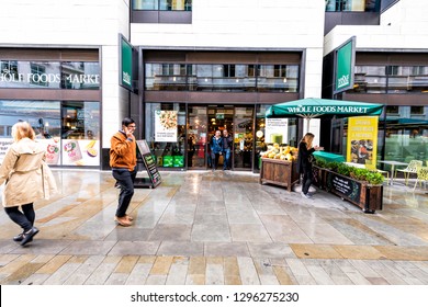 London, UK - September 12, 2018: Whole Foods Market Wholefoods store shop entrance with people on Glasshouse street with rainy wet day in Soho