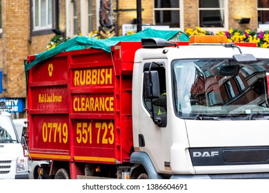 London, UK - September 12, 2018: Street Road With Rubbish Clearance Trash Truck With Sign And Red Color